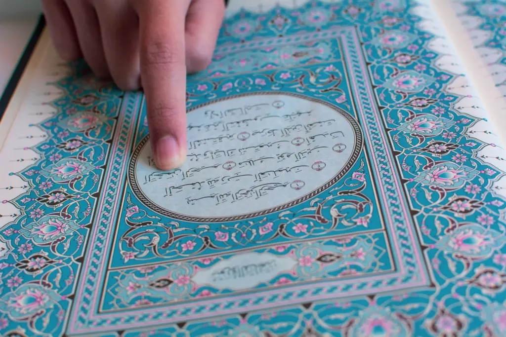 Picture of person reading a passage from the Muslim Koran