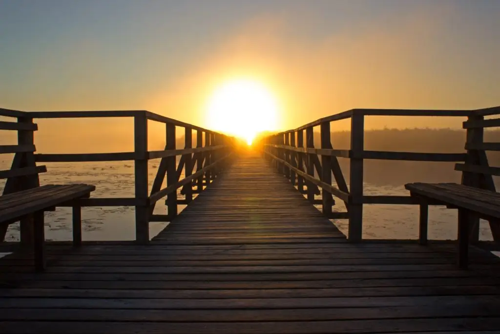 dock sunshine pier sunrise sun sunset water