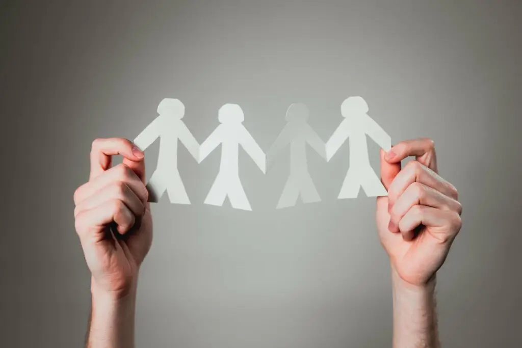 Evangelism vs. Discipleship, shown by 4 paper cut outs touching
