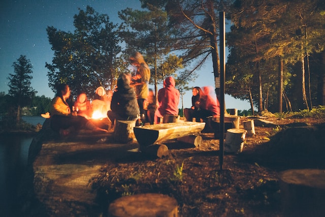 An image of teenagers around campfire representing Dare 2 Share's blog titled 9 Ways to Boost Your Impact by Partnering with Other Ministries.