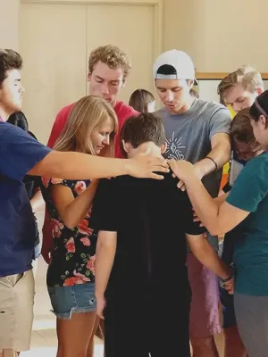 Students in prayer at summer training event